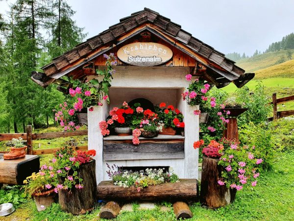 Blumengeschmücckte kleine Hütte auf der Alm