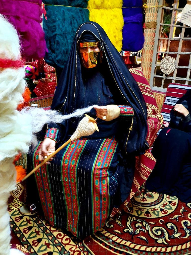 verschleierte arabische Frau spinnt Wolle