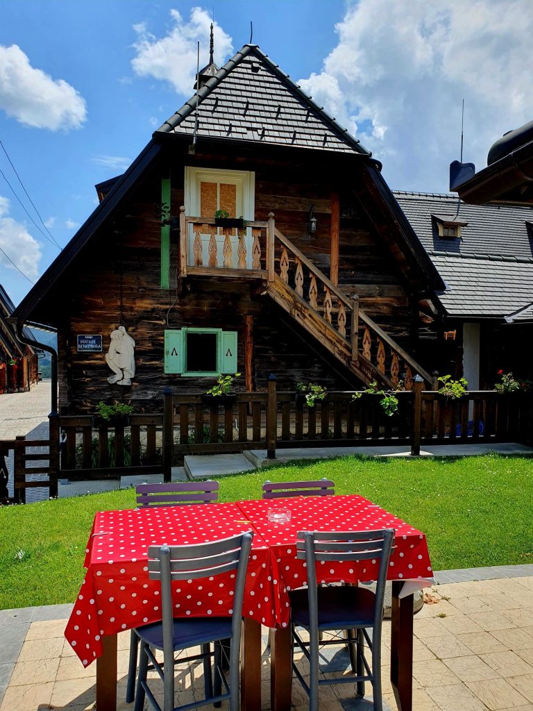 serbisches Holzhaus mit Gartentisch davor